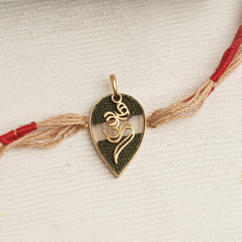 22K Gold Double Om Rakhi with brown & red thread changeable into a pendant